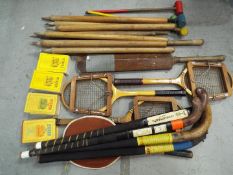 A collection of vintage sporting equipment to include tennis rackets,