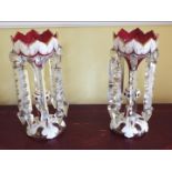 A pair of 20th century Bohemian ruby and white overlay lustres with panels of scroll decoration,