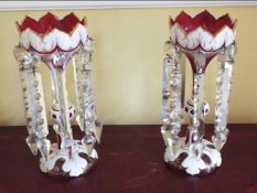 A pair of 20th century Bohemian ruby and white overlay lustres with panels of scroll decoration,