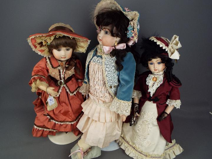 A collection of five beautifully costumed dolls, porcelain heads and hands and fixed glass eyes. - Image 3 of 4