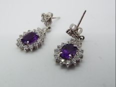 A pair of 9ct white gold and amethyst drop earrings.