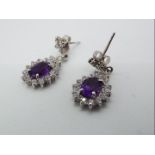 A pair of 9ct white gold and amethyst drop earrings.