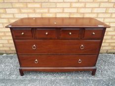 A low chest of three over two drawers measuring approximately 72 cm x 103 cm x 47 cm.