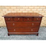 A low chest of three over two drawers measuring approximately 72 cm x 103 cm x 47 cm.