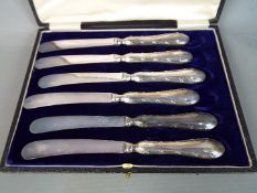 A cased set of George V silver handled butter knives, Sheffield assay 1910,