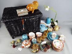 A collection of Oriental styled pottery and treen items together with a wicker hinged-lid fishing