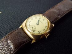 A 9ct gold cased Bernex 15 jewel wristwatch on brown leather strap.