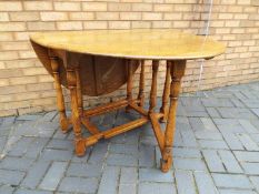A drop leaf kitchen or dining table, approximately 76 cm x 103 cm x 47 cm when unextended.