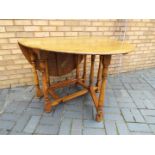 A drop leaf kitchen or dining table, approximately 76 cm x 103 cm x 47 cm when unextended.