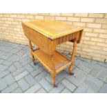 A drop leaf trolley approximately 74 cm x 67 cm x 43 cm when unextended.