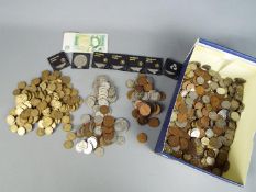 A large quantity of UK and foreign coins, commemorative crowns and similar.