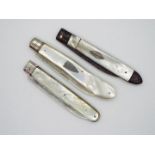 Three folding fruit knives, one white metal bladed example with vacant cartouche to the handle,