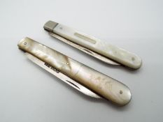 Two George V silver and mother of pearl folding fruit knives,