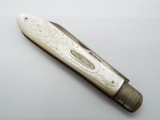 An Edward VII silver and mother of pearl folding fruit knife the handle with floral and butterfly