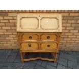A bureau with fall flap front and two drawers, approximately 104 cm x 76 cm x 42 cm.