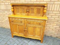 A large sideboard approximately 129 cm x