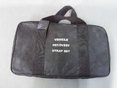 A vehicle recovery strap set in carry ca