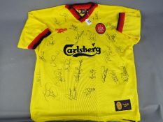 A Liverpool Football Club signed replica shirt from the 1997 - 1998 season bearing 24 signatures