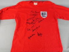 England World Cup Winners - A multi signed long sleeve, replica shirt signed by Nobby Stiles,