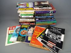 A collection of sporting interest books and magazines covering cricket, Olympics,