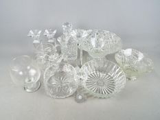 A collection of glassware to include decanter, candlesticks, bowls and similar.