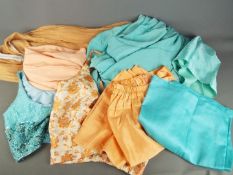 Saree / Sari - A three piece sari set in turquoise and a four piece set in peach tone.