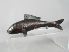 A bronzed sculpture depicting a Koi Carp fish,