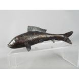 A bronzed sculpture depicting a Koi Carp fish,