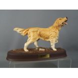 A Beswick pottery figure depicting a Retriever mounted on an oval base,