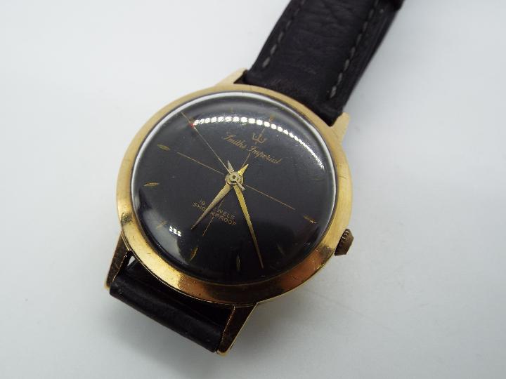 A gentleman's, yellow metal, Smiths Imperial wristwatch with black dial and 19 jewel movement, - Image 3 of 5