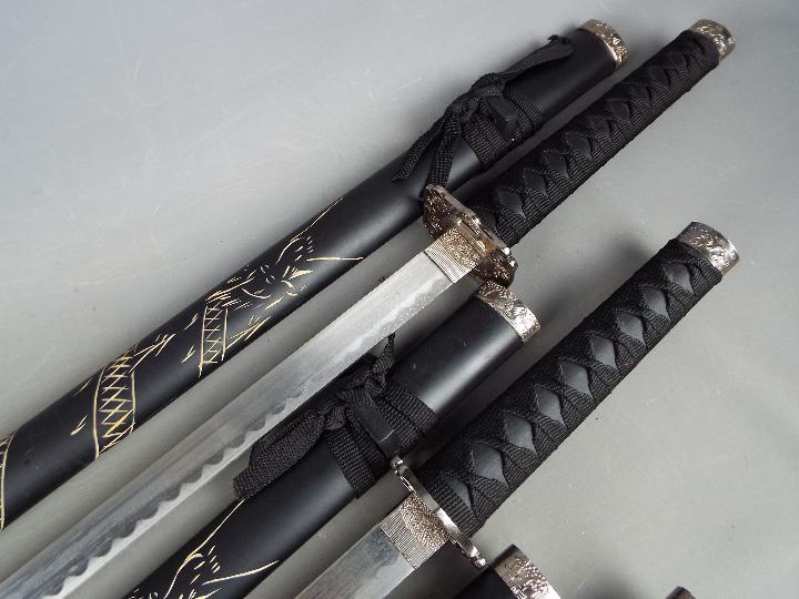 A set of three reproduction Japanese swords, longest approximately 101 cm, - Image 5 of 5