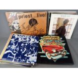 A collection of 12" vinyl records to include Judas Priest, Status Quo, Erasure, The Beach Boys,