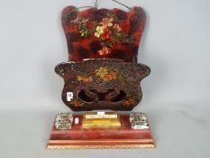 A vintage wall hanging letter rack with floral decoration and a desk tidy with twin glass inkwells.