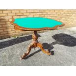A folding card table on highly carved tripod base,