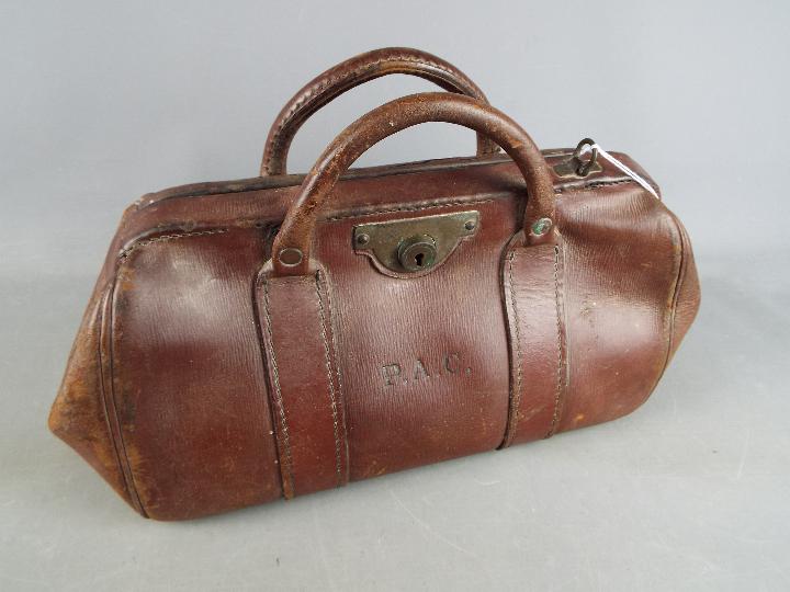 An early 20th century, leather Gladstone bag.