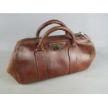 An early 20th century, leather Gladstone bag.