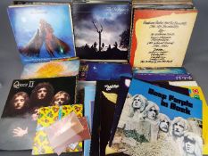 A box of 12" vinyl records to include Deep Purple, Queen, Whitesnake, Rolling Stones, ZZ Top,