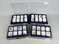 Four display cases, each containing eight boxed mineral samples with labels of origin.