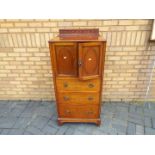 A side cabinet having a cupboard over three drawers, approximately 133 cm x 61 cm x 50 cm.