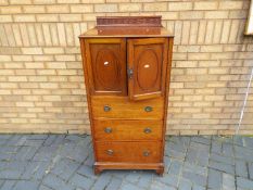 A side cabinet having a cupboard over three drawers, approximately 133 cm x 61 cm x 50 cm.