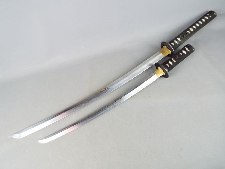 Two reproduction Japanese swords with black lacquered saya, longest approximately 109 cm. - Image 3 of 4