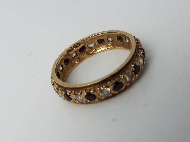 A lady's hallmarked 9 carat yellow gold eternity ring set with red and white stones, approx 2. - Image 2 of 2