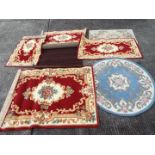 A quantity of rugs and floor coverings, varying sizes.