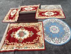 A quantity of rugs and floor coverings, varying sizes.