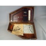 A cased autoharp with song books.