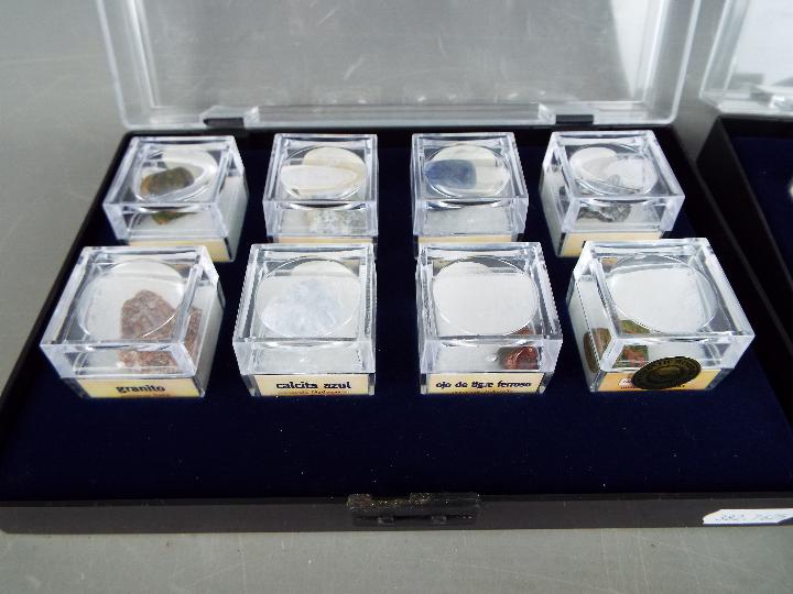 Four display cases, each containing eight boxed mineral samples with labels of origin. - Image 4 of 5