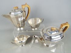 A George V silver four-piece Tea and Coffee set comprising teapot, coffee pot,