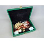 A jewellery box containing a quantity of costume jewellery,