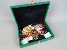 A jewellery box containing a quantity of costume jewellery,