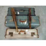A vintage wood and brass carving set and a vintage exercise club and three vintage suitcases.